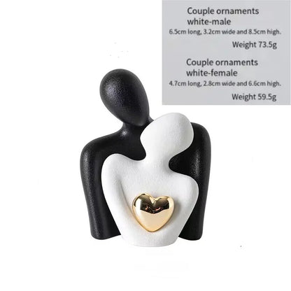 Decoratie woonkamer accessoires - Zwarte en witte sculpturen met gouden hart voor romantische sfeer
