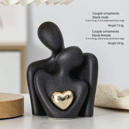 Decoratie woonkamer accessoires - Zwarte en witte sculpturen met gouden hart voor romantische sfeer