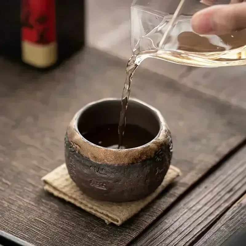 Glazen theepot met theelichtje onderin